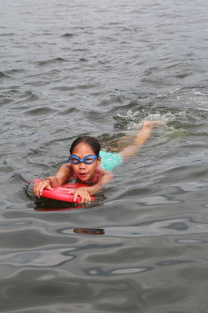 A young girl having fun at summer camp in the water