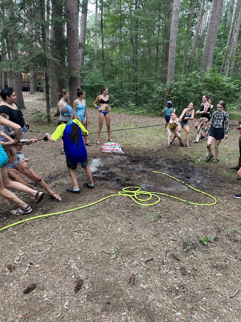 Children working together on a ropes course at camp