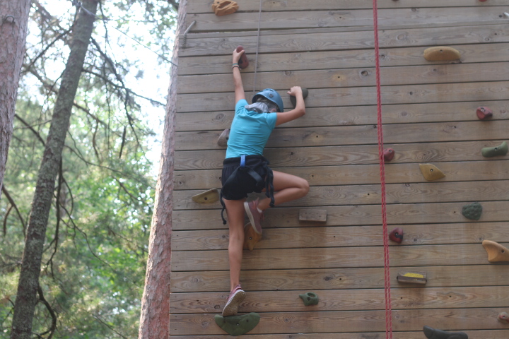 Teenager gaining confidence through outdoor activities at summer camp